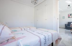 a bedroom with three beds in a room at Awesome Apartment In Torrevieja in Torrevieja +9 photos