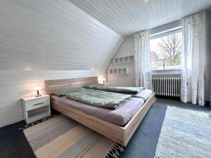 a bedroom with a large bed and a window at Ferienhaus Pfänderblick in Rickenbach