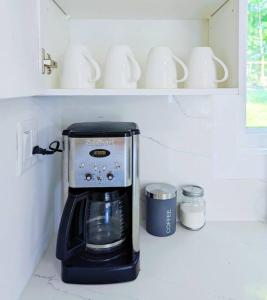 a coffee maker on a counter in a kitchen at The Lilac Bungalow in Kingston