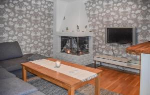 a living room with a couch and a fireplace at 2 Bedroom Lovely Apartment In Lyckeby in Lyckeby