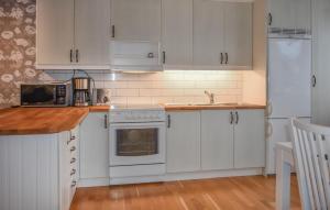 a kitchen with white cabinets and a white oven at 2 Bedroom Lovely Apartment In Lyckeby in Lyckeby