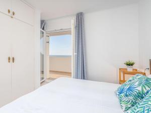 um quarto com uma cama e vista para o oceano em Appartement Empuriabrava, 3 pièces, 4 personnes - HISP-288-37 em Empuriabrava