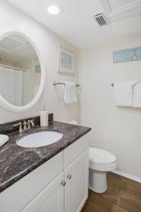 a bathroom with a sink and a toilet and a mirror at 1316 Pelican Watch Villas Seabrook Island SC in Seabrook Island