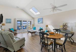 a living room with a couch and a table with chairs at 1316 Pelican Watch Villas Seabrook Island SC in Seabrook Island