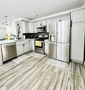 a kitchen with white cabinets and stainless steel appliances at *The Gemstone* Newly Renovated, Stylish, Spacious in Ladson