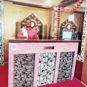 a man is standing behind a pink and black at Light House By Leisure Hospitality in Rishīkesh