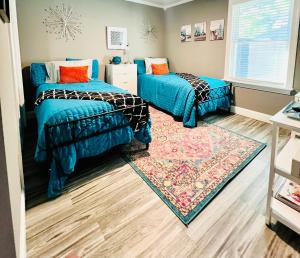 a bedroom with two beds and a rug at *The Gemstone* Newly Renovated, Stylish, Spacious in Ladson