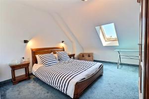 a bedroom with a bed with striped sheets and a table at Villa cafe marrec 8 in Port-Louis