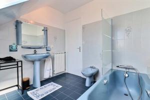 a bathroom with a sink and a tub and a toilet at Villa cafe marrec 8 in Port-Louis +18 photos