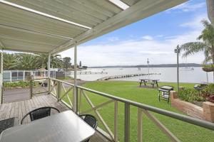 a balcony with a view of a body of water at Paradise Palms Caravan Park in Rathmines