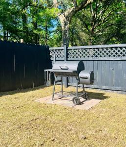a barbecue grill sitting on a table in a yard at *The Gemstone* Newly Renovated, Stylish, Spacious in Ladson