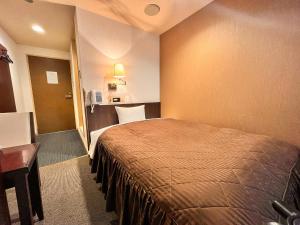 札幌市にあるホテル翔 SAPPOROのベッドとデスクが備わるホテルルームです。