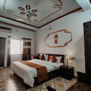 a bedroom with a large bed and a ceiling at Light House By Leisure Hospitality in Rishīkesh