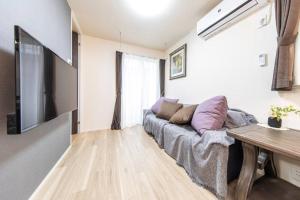 TV a/nebo společenská místnost v ubytování Maizon de Aile Room B