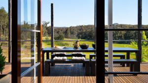 a patio with a table and a view of a field at The Welcome Paddock in Hepburn