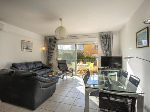 a living room with a couch and a glass table at Casa con piscina privada a 100m de la playa, ideal para familias - HISP-288-61 in Empuriabrava