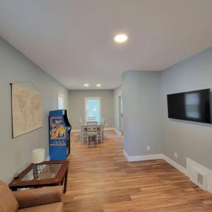 a living room with a couch and a flat screen tv at Beautiful Renovated 4 Bedroom. Walk to Niagara Falls. in Niagara Falls