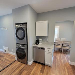 a kitchen with a washing machine in a room at Beautiful Renovated 4 Bedroom. Walk to Niagara Falls. in Niagara Falls