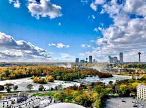 an aerial view of a city with a river and buildings at Beautiful 4 bedroom home short walk to Niagara Falls in Niagara Falls