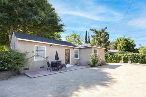 una piccola casa bianca con tavolo e sedie di Balcom by AvantStay Newly Furnished Valley Home a Los Angeles