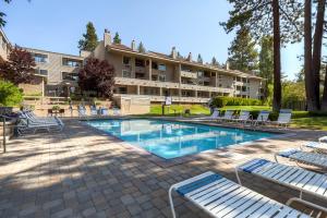 a hotel with a swimming pool with lounge chairs at Lakeland Village 521 - Come Lake It in South Lake Tahoe