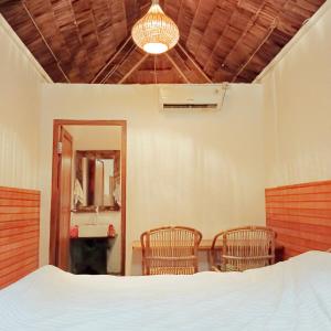 A bed or beds in a room at Bunaken 18 Diving Resort and Cafe