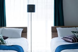 Postel nebo postele na pokoji v ubytování SG RESIDENCE INN HAKATA