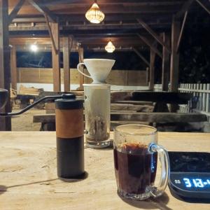 a cup of coffee sitting on a wooden table with a drink at Bunaken 18 Oceanfront Boutique Lodge in Bunaken +97 photos