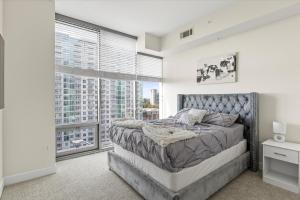 a bedroom with a bed and a large window at Luxury Living In Buckhead in Atlanta