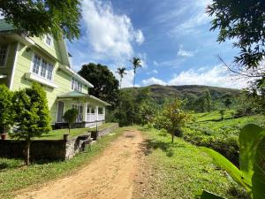 a dirt road in front of a house at Lavender Plantation Stay vagamon in Vagamon