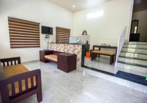 a living room with tables and chairs and a fireplace at Lavender Plantation Stay vagamon in Vagamon