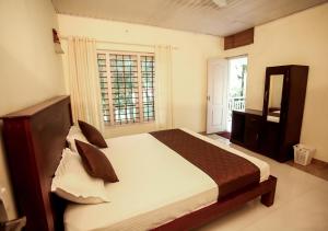 a bedroom with a large bed and a window at Lavender Plantation Stay vagamon in Vagamon +39 photos