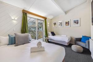 a large room with two beds and a window at Tyrola 2 in Thredbo