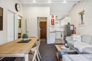 a kitchen and living room with a table and a couch at Tyrola 2 in Thredbo