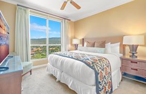 a bedroom with a bed and a large window at KBM Resorts: Honua Kai HKK-820 Includes Rental Car in Kaanapali