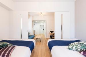 Postel nebo postele na pokoji v ubytování SG RESIDENCE INN HAKATA