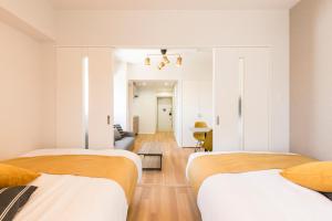 Postel nebo postele na pokoji v ubytování SG RESIDENCE INN HAKATA