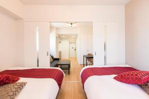 Postel nebo postele na pokoji v ubytování SG RESIDENCE INN HAKATA