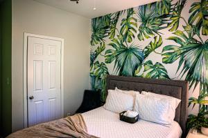 a bedroom with a bed with a plant wall at Stylish Cozi Abode of Atlanta in Atlanta