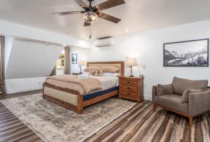 a bedroom with a bed and a chair at Peyton's Luxury Suite in Oakhurst