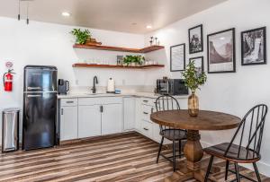 a kitchen with a table and a refrigerator at Peyton's Luxury Suite in Oakhurst