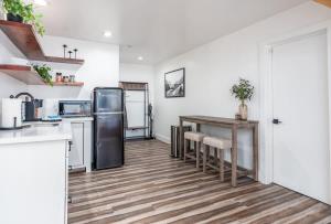 a kitchen with a table and a refrigerator at Four Daughters Inn Suite in Oakhurst