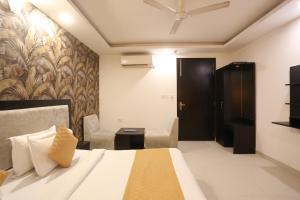a hotel room with a bed and a chair at Hotel Aashiyana Palace Just 4Km Away From Delhi Airport in New Delhi