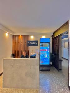 a man sitting at a counter in an office at Hotel Citadin Z10 in Guatemala