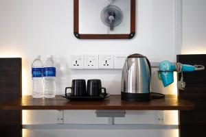 eine Theke mit Kaffeemaschine und Wasserflaschen darauf in der Unterkunft Paya Debloc Village in Tioman Island
