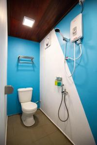 a bathroom with a toilet and a shower at Paya Debloc Village in Tioman Island