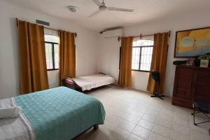 a bedroom with two beds and two windows at casa completa en Villahermosa in Villahermosa