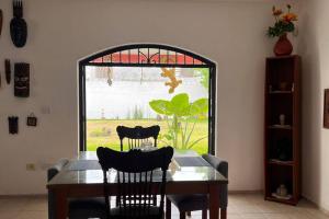 a dining room with a table and chairs and a window at casa completa en Villahermosa in Villahermosa