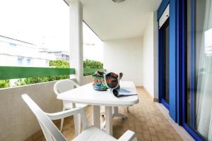 a white table and chairs on a balcony at Apartment in Bibione near tennis court in Bibione