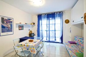a living room with a table and a couch at Apartment in Bibione near tennis court in Bibione